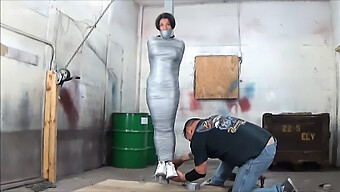 Busty Girl Restrained With Duck Tape On A Pole